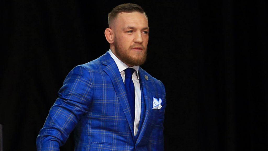 Conor McGregor struts in a blue designer suit