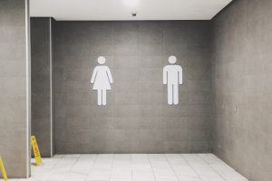 womens and mens bathroom signs symbolizing the lessening of trips to pee and how to prevent a hangover