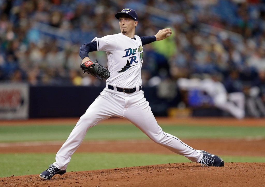Donning the Tampa Bay Devil Rays throwback uniform, left-handed pitcher Blake Snell fires a pitch in the top of the first inning
