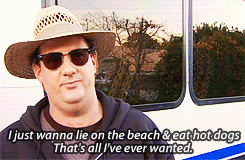 kevin malone talking about living his best life on the beach eating hot dogs.
