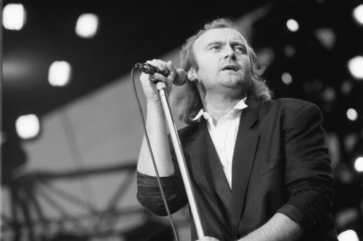 Phil Collins rocking the stage as a lead singer for Genesis in the 1980s.