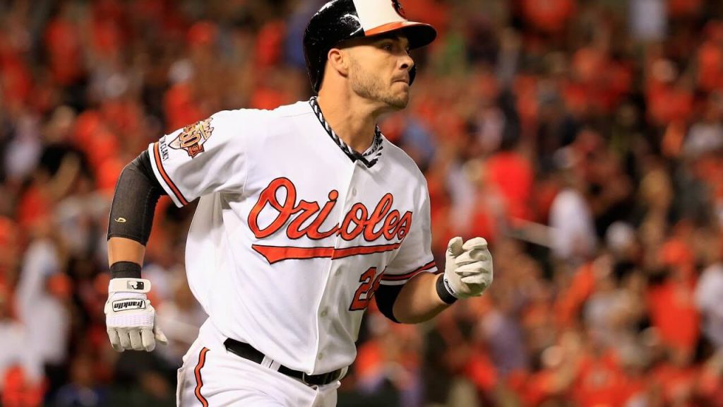 Steve Pearce trots to first base in the postseason for the Baltimore Orioles, surrounded by a packed house of towel-waving fans