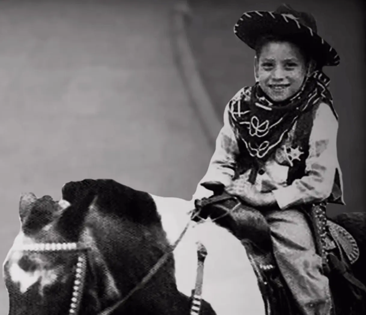 Danny Trejo as a child riding a horse.