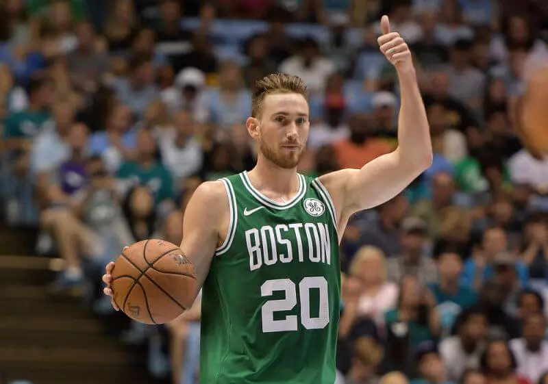 Gordon Hayward flashes a thumbs up to his teammates while dribbling during a game for the Boston Celtics. Gordon Hayward's Return to the NBA, a story by Joker Mag - the home of the underdog.