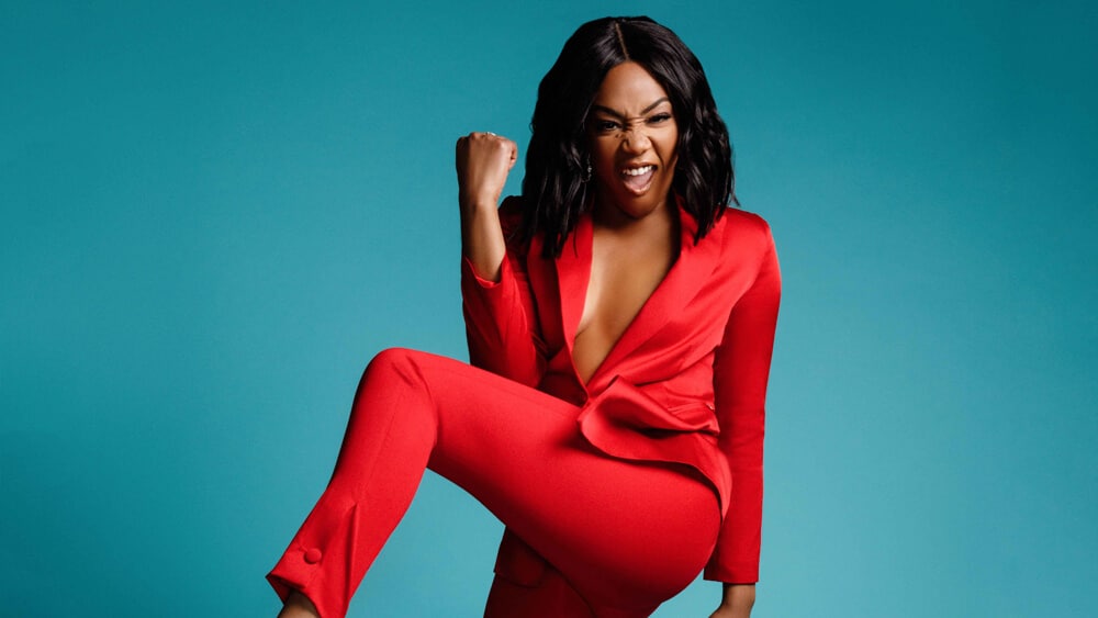 Tiffany Haddish wears a red pantsuit in a photoshoot for Variety.