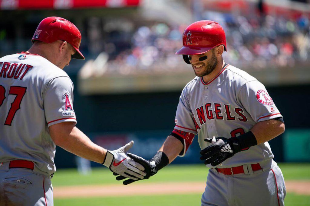 Tommy La Stella high-fives Mike Trout after blasting a home run into the right field seats during the 2019 MLB season.