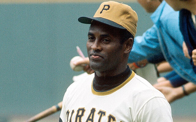 Roberto Clemente wears the Pirates alternate solid gold baseball hat