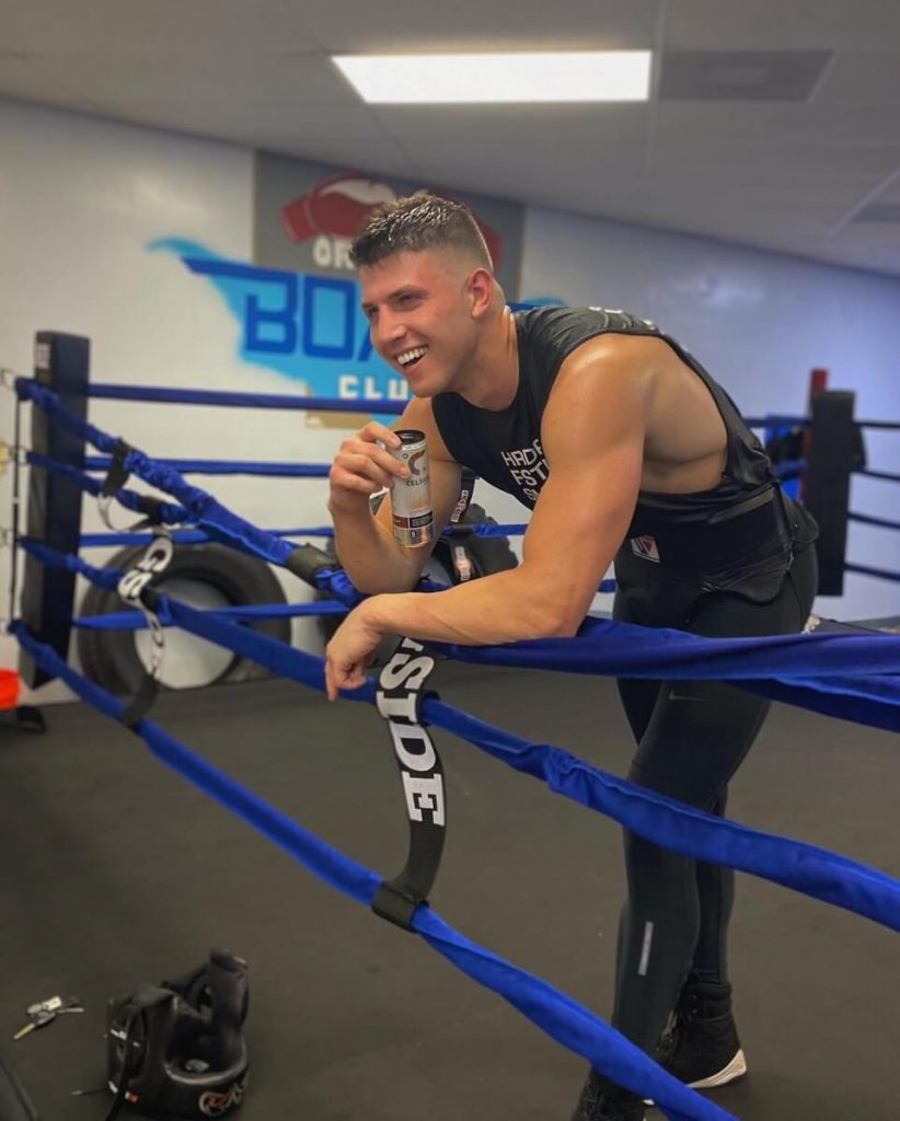 Adrian Pinheiro in the ring sipping water between sparring sessions