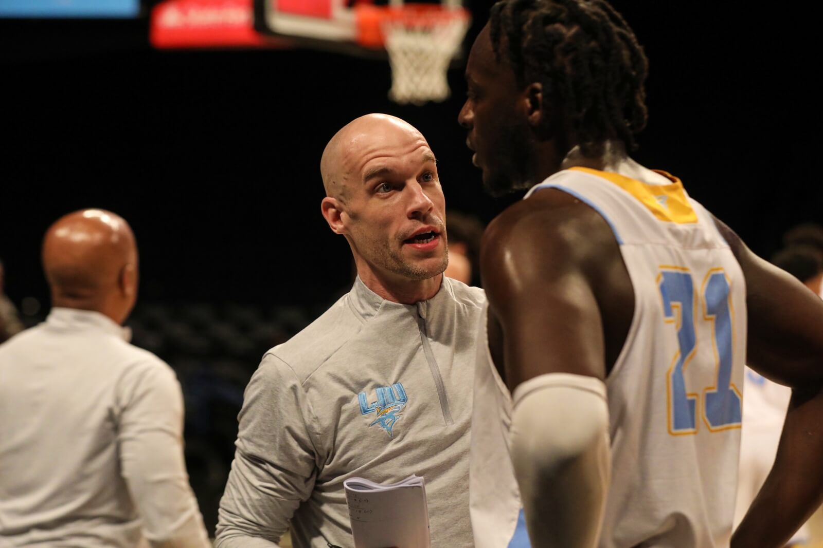 LIU Basketball assistant coach Chris Thomas hypes up his players during an NCAA men's basketball matchup